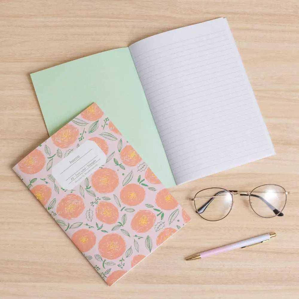 Apica Hocco A5 defter ahşap masada açık, 7 mm çizgili sayfalar, yanında gözlük ve pastel kalem