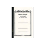 Apica CD-11 A5 defterin krem kapağı, süslü çerçeveli NOTE BOOK baskısı ve siyah bez sırt