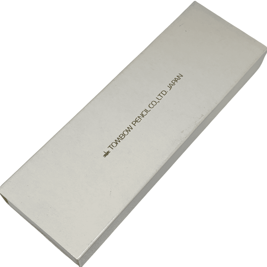 Tombow Exta Deluxe kaleminin beyaz dış kutusu, üzerinde yaldızlı Tombow Pencil Co. Japan yazısı ve yusufçuk logosu